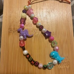 ADHD awareness phone wristlet/charm w/dinosaurs colorful
